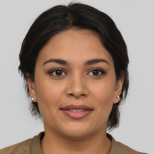 Joyful latino young-adult female with medium  brown hair and brown eyes