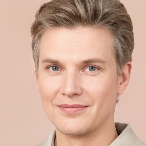 Joyful white adult male with short  brown hair and grey eyes