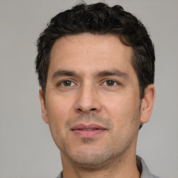 Neutral white adult male with short  black hair and brown eyes