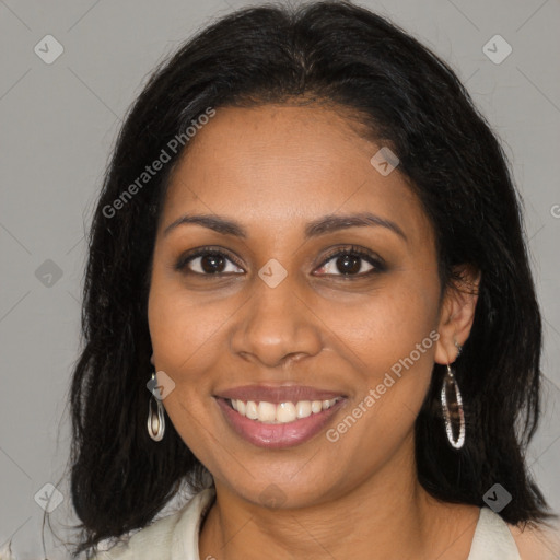 Joyful black young-adult female with long  brown hair and brown eyes