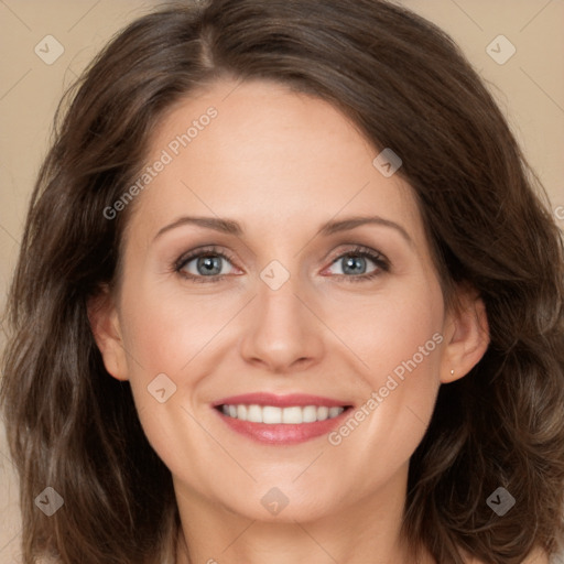 Joyful white adult female with long  brown hair and brown eyes