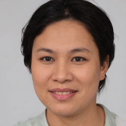 Joyful asian young-adult female with medium  brown hair and brown eyes