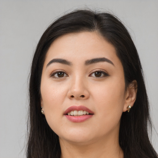 Joyful asian young-adult female with long  brown hair and brown eyes