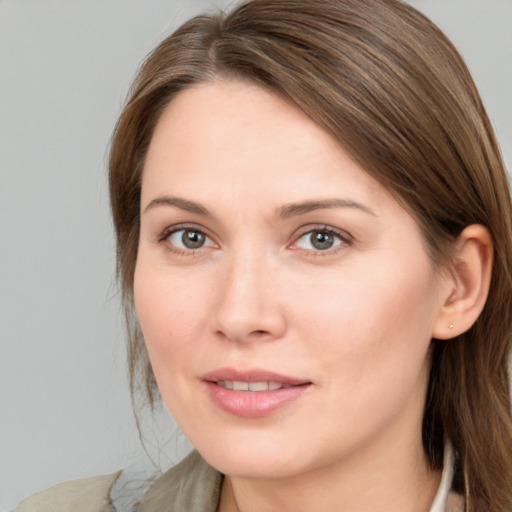 Joyful white young-adult female with medium  brown hair and grey eyes