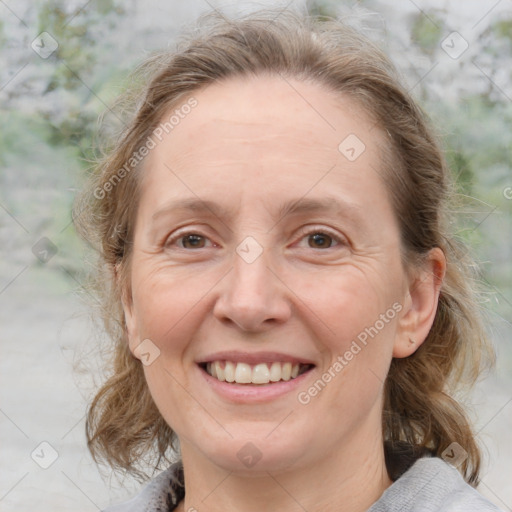 Joyful white adult female with medium  brown hair and blue eyes