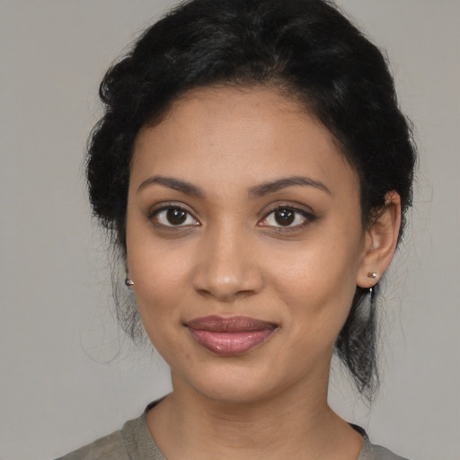 Joyful latino young-adult female with medium  black hair and brown eyes