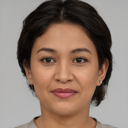 Joyful asian adult female with medium  brown hair and brown eyes