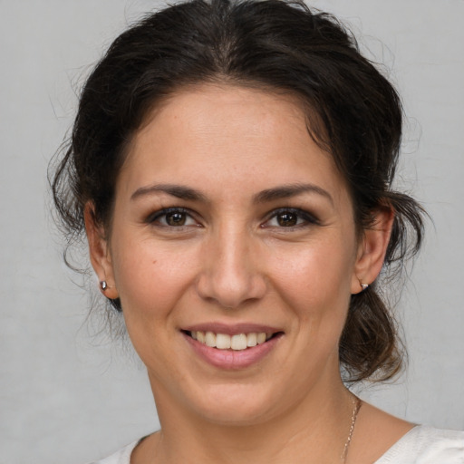 Joyful white young-adult female with medium  brown hair and brown eyes