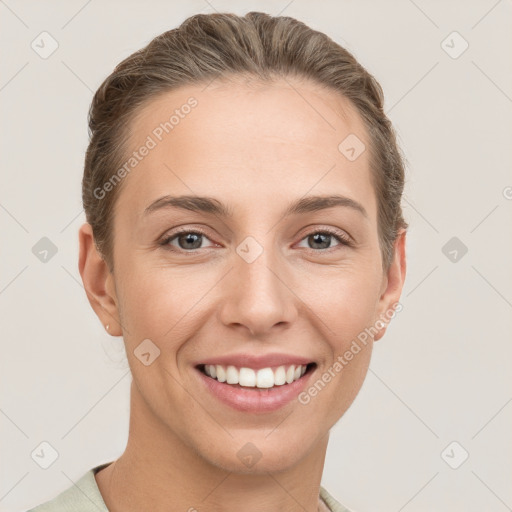 Joyful white young-adult female with short  brown hair and grey eyes