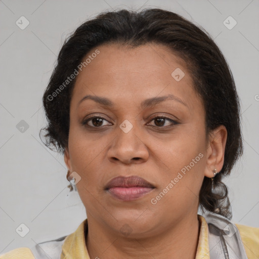 Joyful latino adult female with medium  brown hair and brown eyes