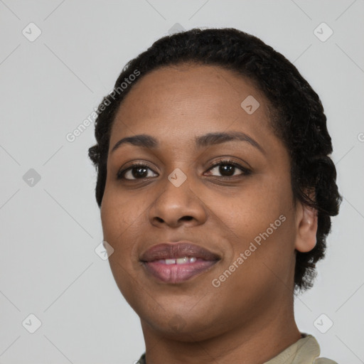 Joyful black young-adult female with short  black hair and brown eyes