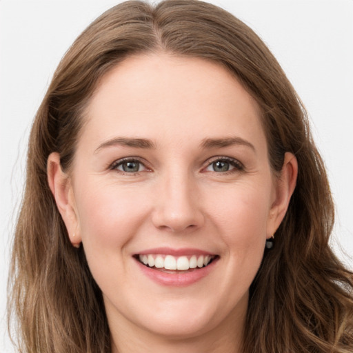 Joyful white young-adult female with long  brown hair and grey eyes