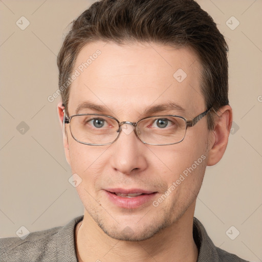 Joyful white adult male with short  brown hair and grey eyes