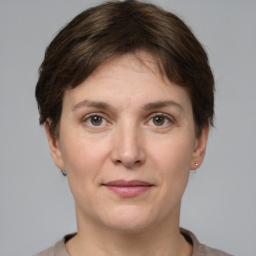 Joyful white adult female with short  brown hair and grey eyes