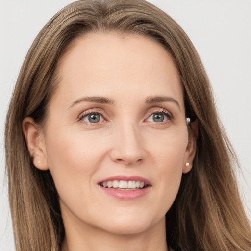 Joyful white young-adult female with long  brown hair and grey eyes