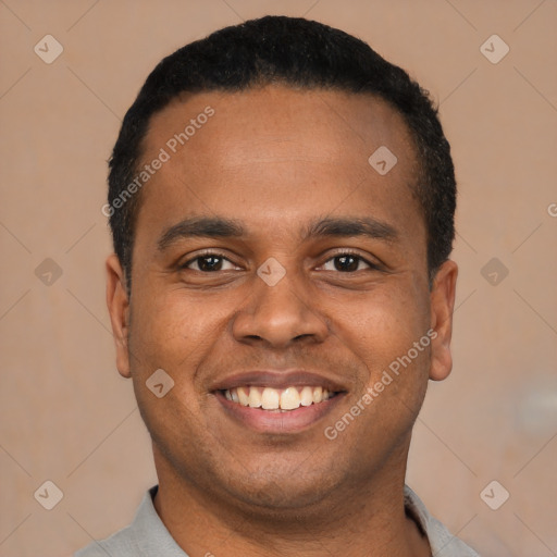 Joyful latino young-adult male with short  black hair and brown eyes