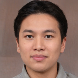 Joyful asian young-adult male with short  brown hair and brown eyes