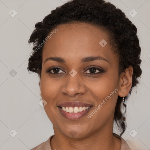 Joyful black young-adult female with long  brown hair and brown eyes