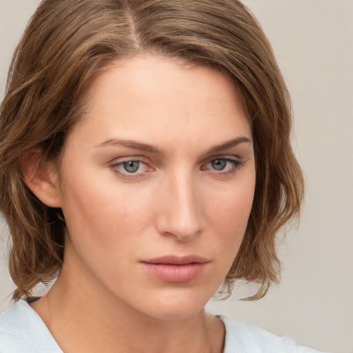 Neutral white young-adult female with medium  brown hair and green eyes