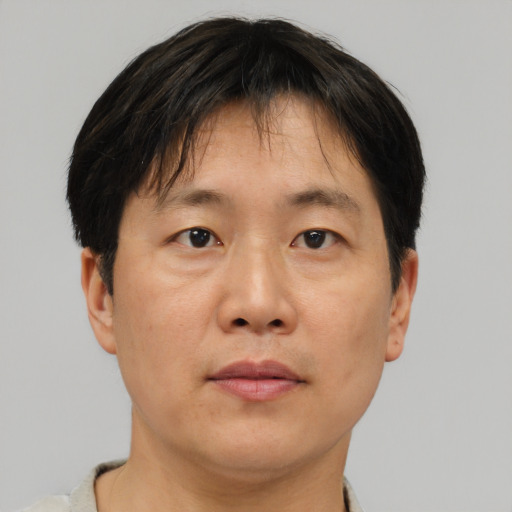 Neutral asian adult male with short  brown hair and brown eyes