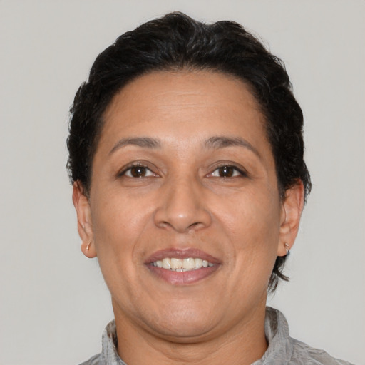 Joyful latino adult female with short  brown hair and brown eyes