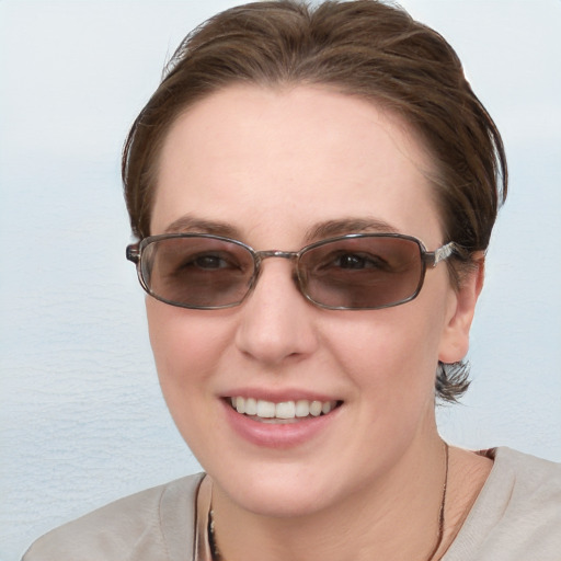 Joyful white young-adult female with medium  brown hair and blue eyes