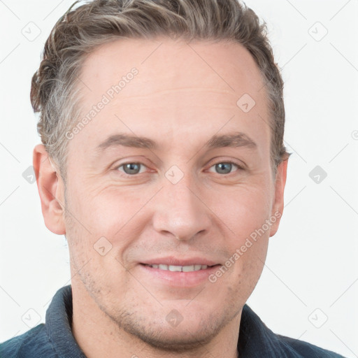 Joyful white adult male with short  brown hair and grey eyes