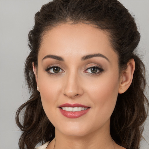 Joyful white young-adult female with long  brown hair and brown eyes