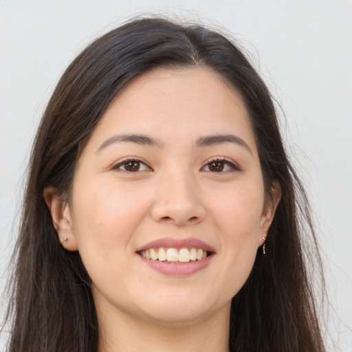 Joyful asian young-adult female with long  brown hair and brown eyes
