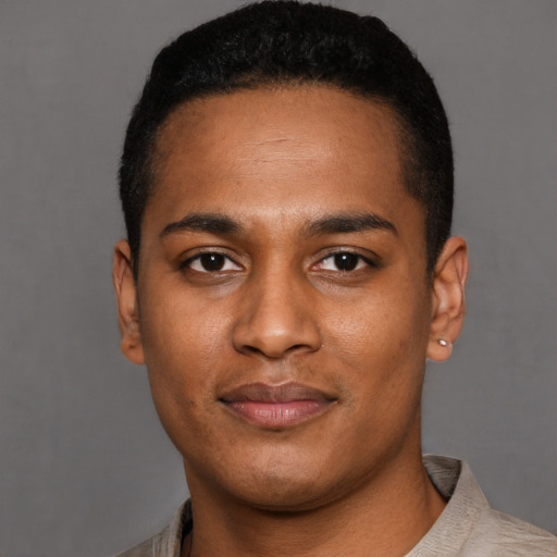 Joyful latino young-adult male with short  black hair and brown eyes