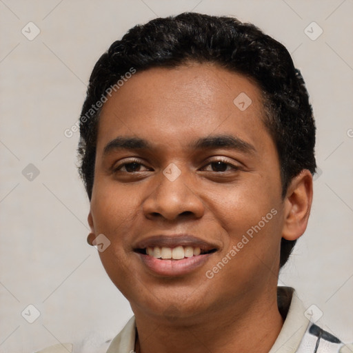 Joyful black young-adult male with short  black hair and brown eyes