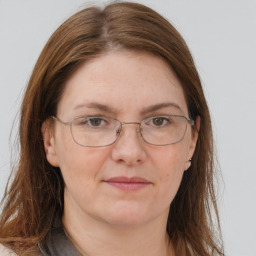 Joyful white adult female with long  brown hair and brown eyes