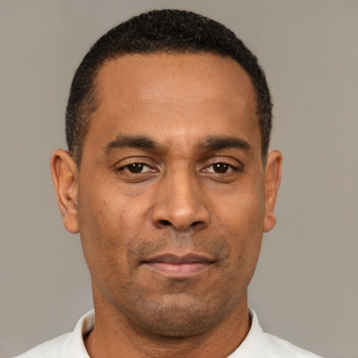 Neutral latino adult male with short  black hair and brown eyes