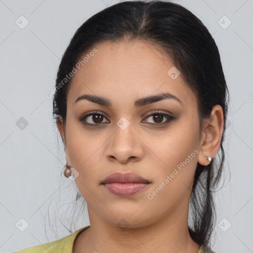 Joyful latino young-adult female with long  brown hair and brown eyes