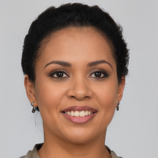 Joyful latino young-adult female with short  brown hair and brown eyes