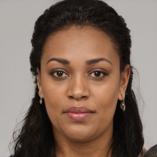 Joyful black young-adult female with long  black hair and brown eyes