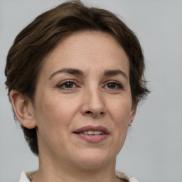 Joyful white adult female with short  brown hair and brown eyes