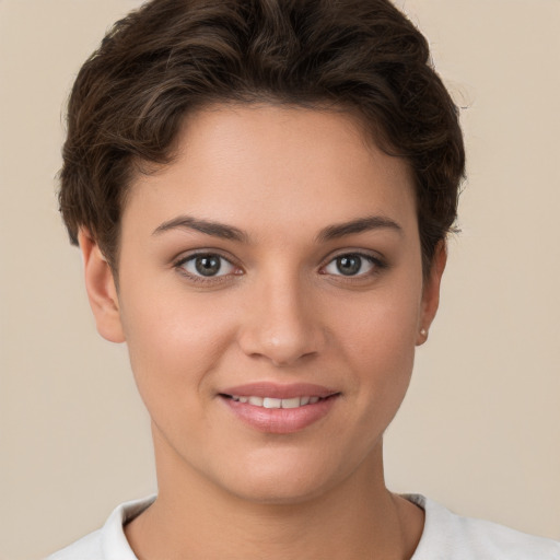 Joyful white young-adult female with short  brown hair and brown eyes