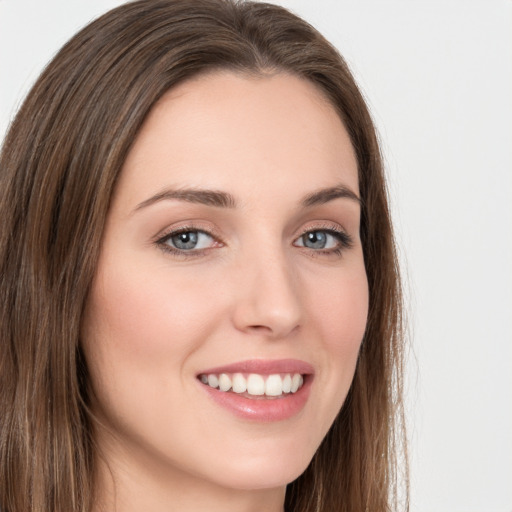 Joyful white young-adult female with long  brown hair and green eyes