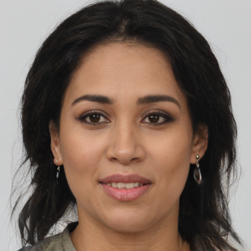 Joyful latino young-adult female with medium  brown hair and brown eyes