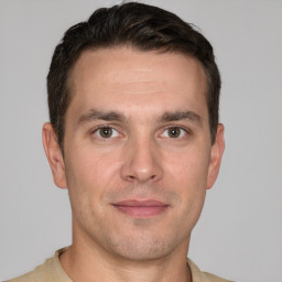 Joyful white adult male with short  brown hair and grey eyes