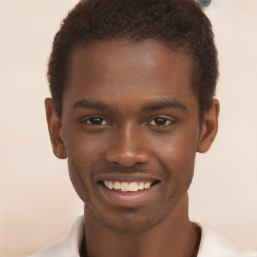 Joyful black young-adult male with short  brown hair and brown eyes