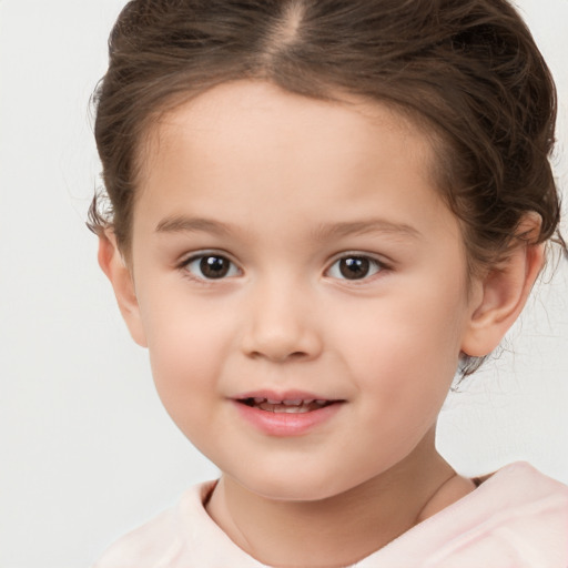 Joyful white child female with short  brown hair and brown eyes