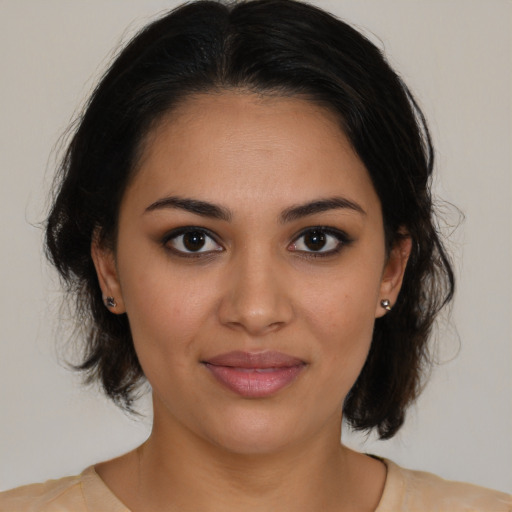 Joyful latino young-adult female with medium  brown hair and brown eyes