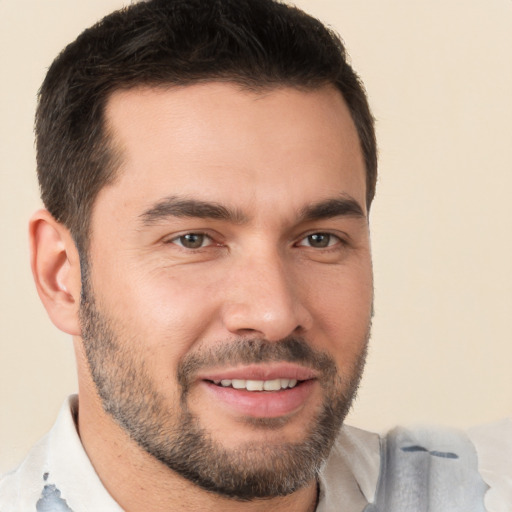 Joyful white young-adult male with short  brown hair and brown eyes