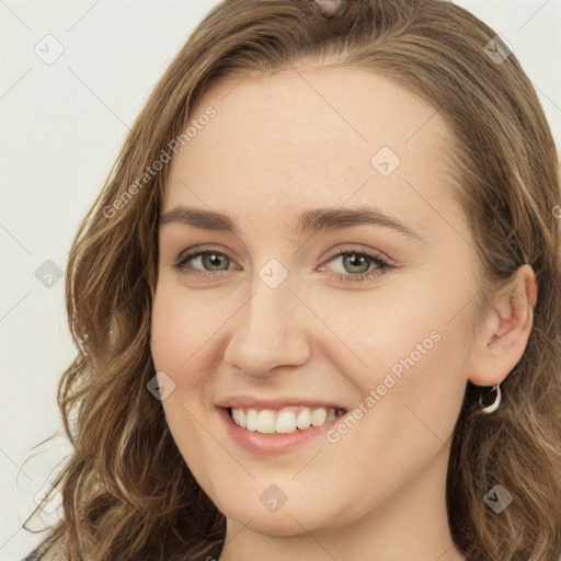 Joyful white young-adult female with long  brown hair and green eyes