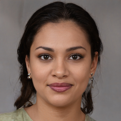 Joyful latino young-adult female with medium  brown hair and brown eyes