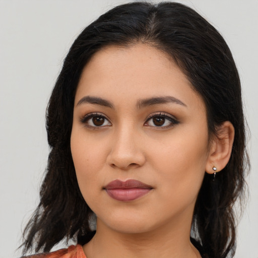 Joyful latino young-adult female with medium  brown hair and brown eyes