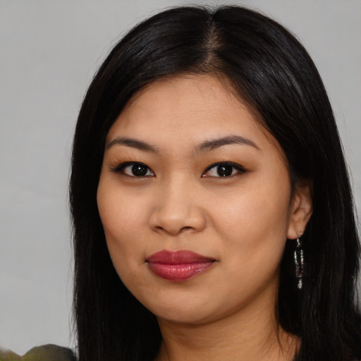 Joyful latino young-adult female with long  black hair and brown eyes