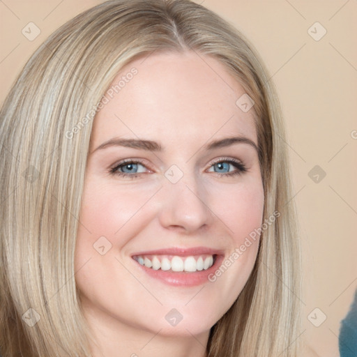 Joyful white young-adult female with long  brown hair and blue eyes